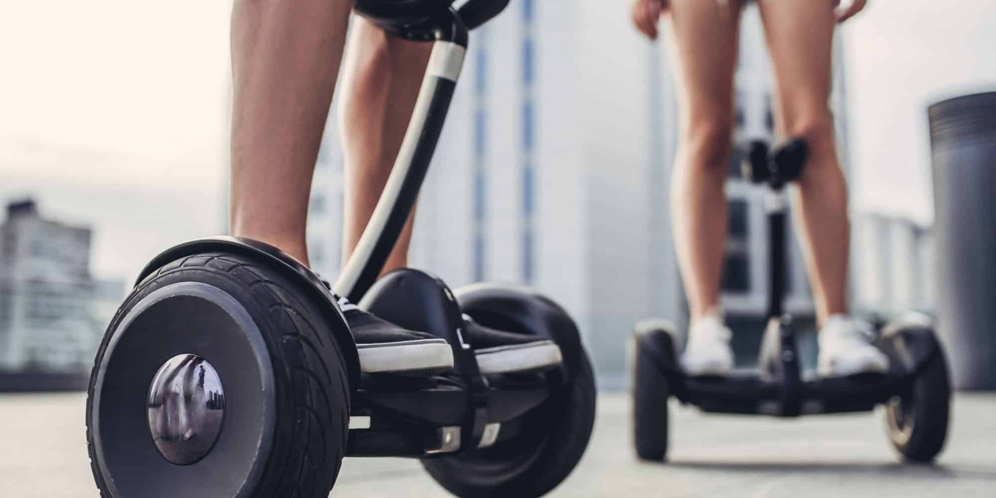What Are The Laws on Electric Scooters in Michigan? Two teenagers using electric scooters in the streets of Lansing