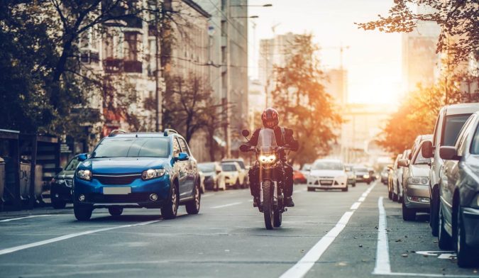Motorcycle and cars on street