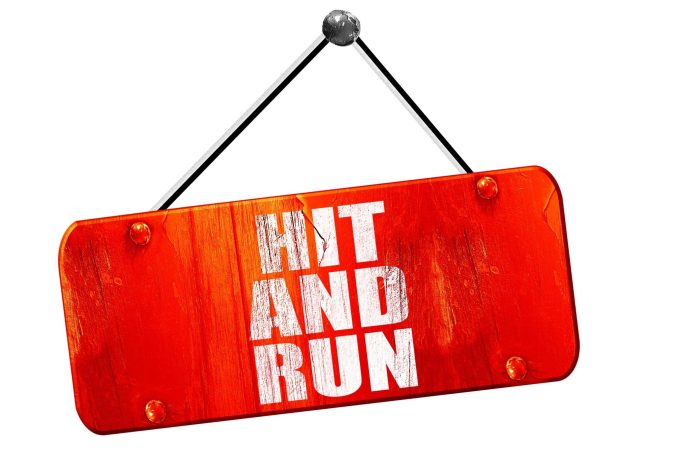 Red sign stating hit and run