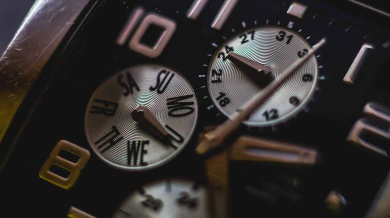 Understanding Time Limits in Filing a Lansing Personal Injury Case Close-up of a watch face featuring Roman numerals, weekday sub-dials, and 24-hour indicators with metallic hands pointing to various times—a reminder of the ticking clock in Lansing, MI, where the file time limit for a personal injury lawsuit should never be overlooked.