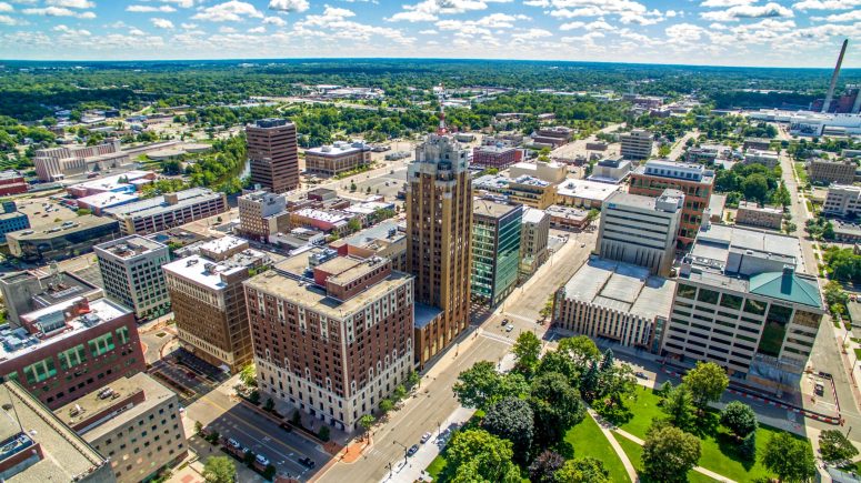 Injured in Lansing Aerial view of Lansing’s cityscape, featuring mid-sized buildings, streets, and lush greenery under a partly cloudy sky. It's a vibrant backdrop to all you need to know about the area, from local life to personal injury cases.