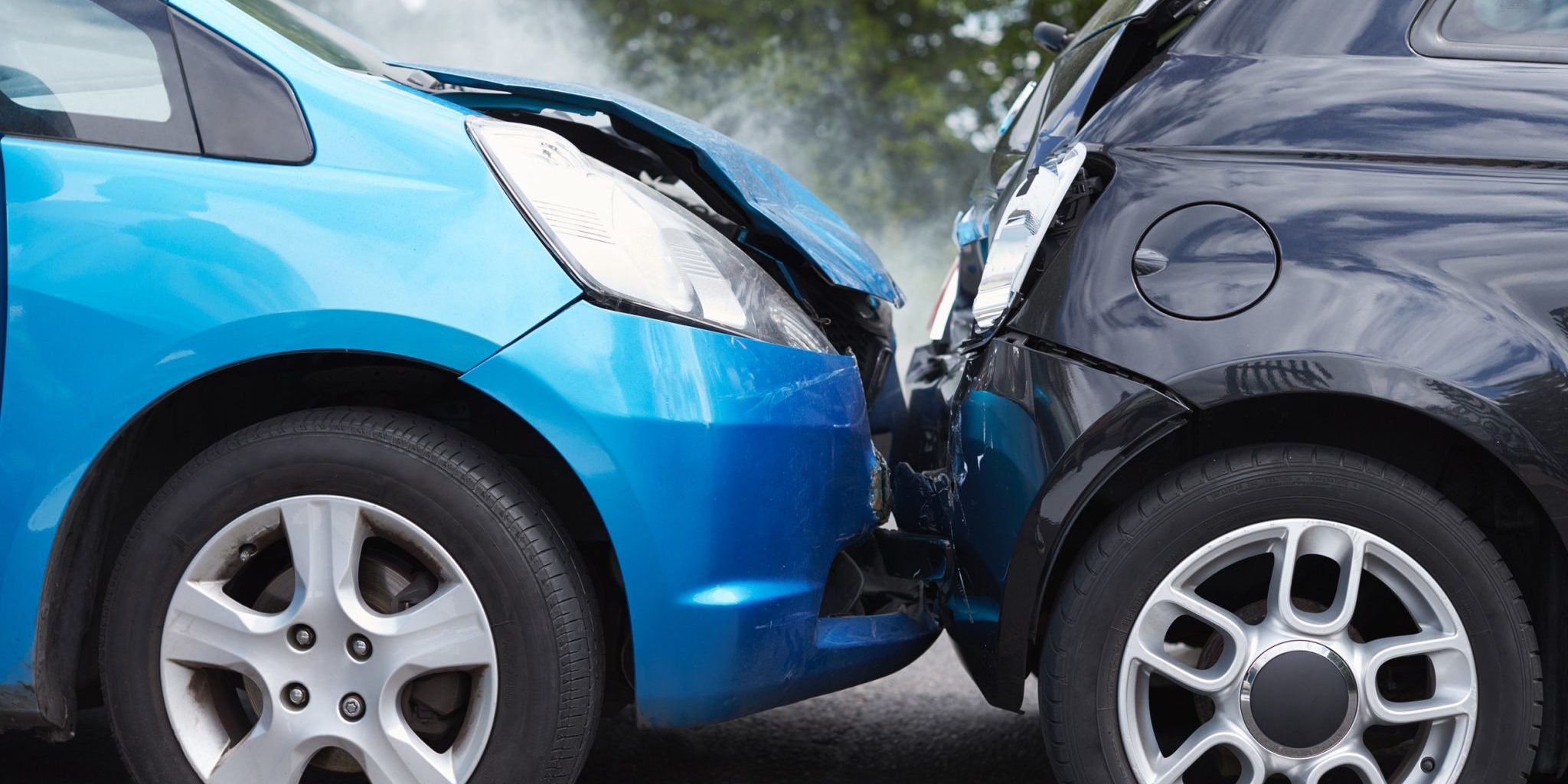 Why Rear-End Crashes Are So Common on Lansing’s Busy Roads A blue car and a black car are involved in a rear-end crash on Lansing roads, with visible damage to both vehicles.