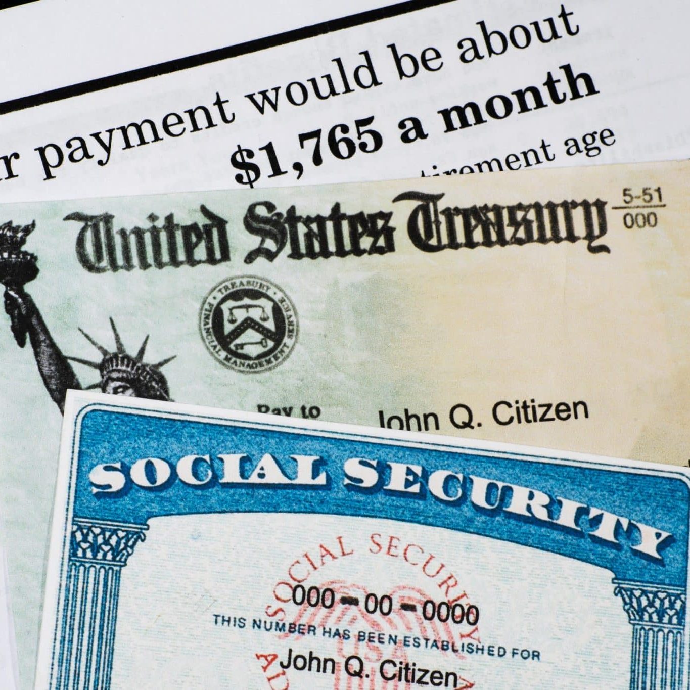 A Social Security card and a U.S. Treasury check are placed on top of a document showing a monthly payment amount of $1,765.