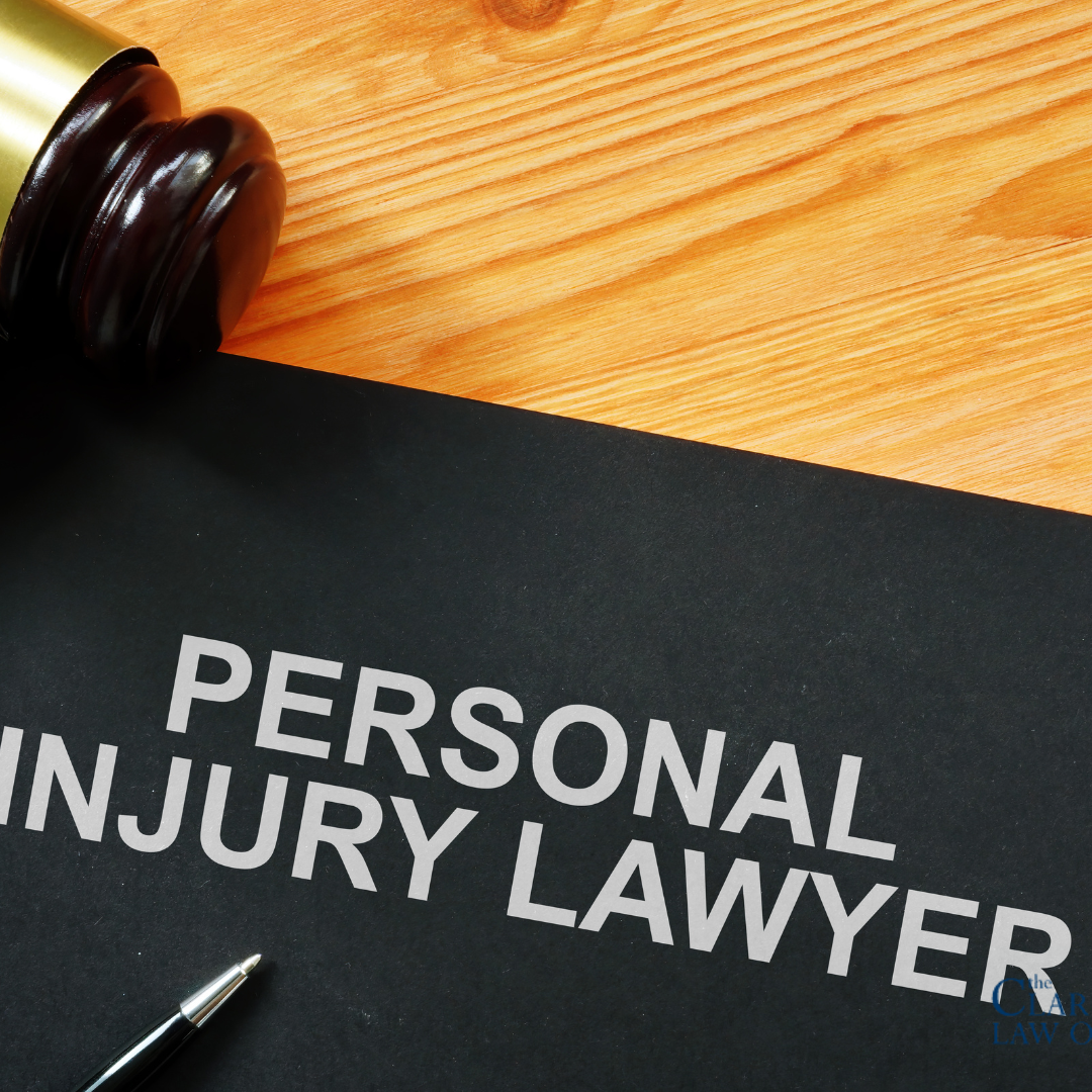 A black folder labeled “Personal Injury Lawyer” lies on a wooden desk next to a judge’s gavel and a pen. A black folder labeled "Personal Injury Lawyer" lies on a wooden desk next to a judge's gavel and a pen.