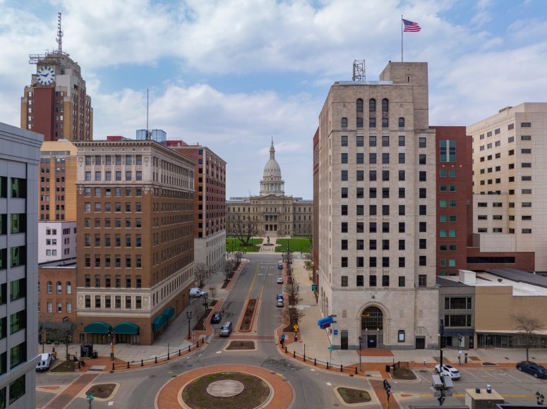 Frandor Dangerous corridor in Lansing A view down a city street leading to a domed capitol building, surrounded by tall office buildings and a roundabout in the foreground.