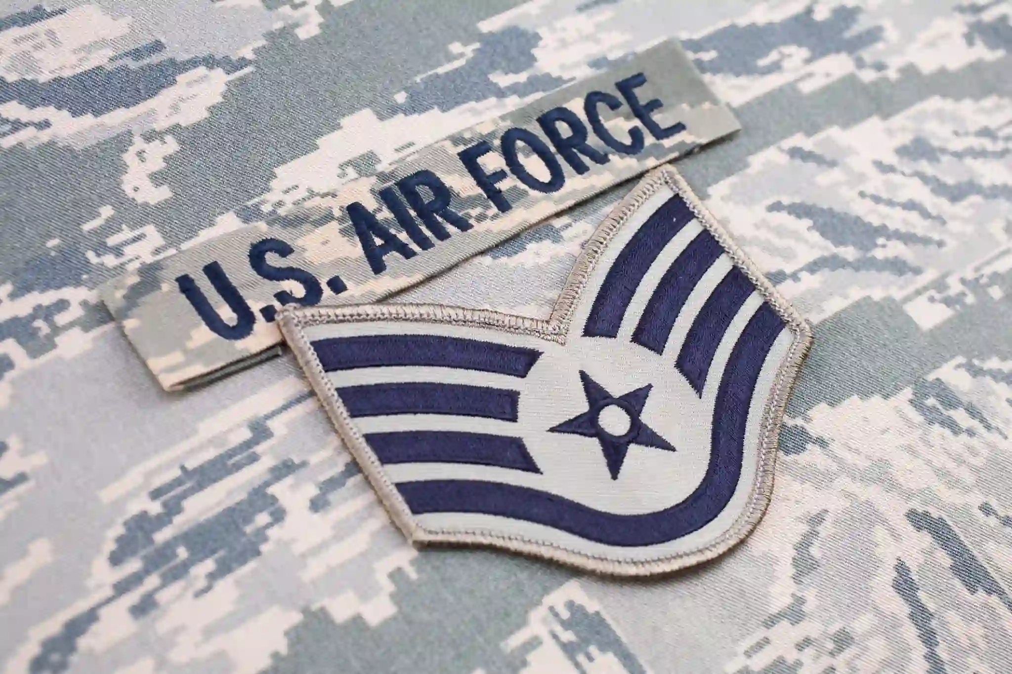 U.S. Air Force uniform details displayed on camouflage fabric background for motorcycle accident case study